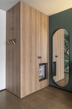 an empty room with a mirror and some cupboards on the wall next to it