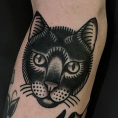 a black and white cat tattoo on the right arm, with an instagram message below