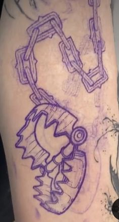 this is an image of someone's leg with a tattoo on it that looks like they have chains attached to them