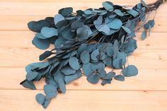 some green leaves are laying on a wooden surface and ready to be cut into pieces