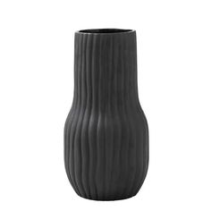 a black vase sitting on top of a white table