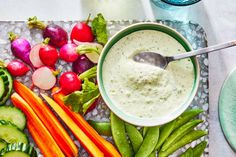 a table topped with vegetables and dip