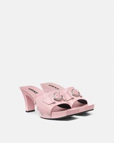 Medusa Buckle Patent Clogs 2.4" Pink | VERSACE US Designer High Heel Mules With Buckle Closure, Luxury Clogs With Wooden Open Heel, Formal Summer Clogs With Reinforced Heel, Luxury Mules With Wooden Heel For Spring, Luxury Summer Clogs With Wooden Heel, Luxury Spring Clogs, Luxury Summer Mules With Wooden Heel, Luxury Mules With Wooden Heel For Summer, Luxury Open Toe Clogs With Platform