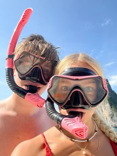 two people wearing scuba gear and snorkels