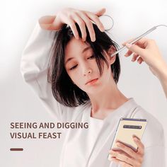 the woman is using her cell phone to check her hair