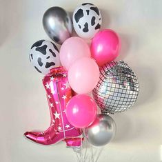 a bunch of balloons that are in the shape of a cowboy boot and some disco balls