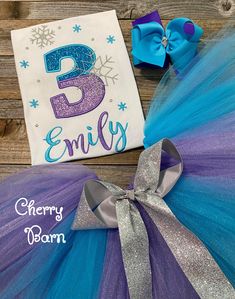 a purple and blue birthday tutu with the number three on it's side