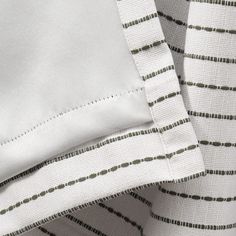 close up view of white and green striped sheets