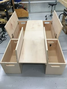 an unfinished desk with two drawers in the middle and one drawer open to show what's inside