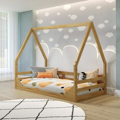 a child's bed with a canopy and pillows on it in a white room