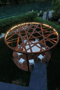 an outdoor table and chairs are lit up at night in the yard with lights on