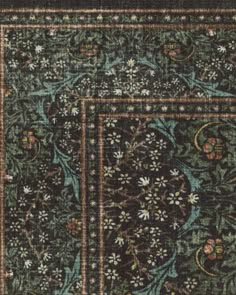 an area rug with various designs and colors on the carpet, including blue, green, brown