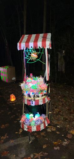 Our community does a yearly haunted trail. We have over 19 stations along the trail. My family does the clown section. This year we decided to add a food cart and had a scary clown push it.  It was well received, and the kids loved it. I purchased a lot of stuff from the Dollar tree.  We used black light paint and made fake traditional carnival/circus treats with plastic bugs and snakes.  I purchased battery operated  black light and attached them to cart. Creepy Carnival Decorations Diy Outdoor, Creepy Carnival Trunk Or Treat, Spooky Carnival Games, Diy Haunted Trail, Diy Halloween Carnival Decorations, Spooky Trail Ideas, Scary Circus Halloween Decorations, Haunted Trail, Halloween Trail Ideas