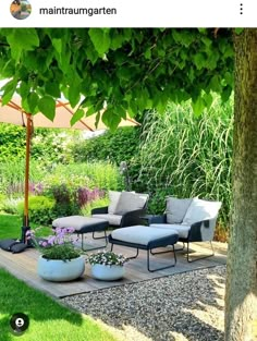 an outdoor seating area in the middle of a garden