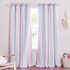 a child's room with pink, blue and white curtains