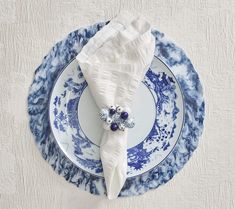 a blue and white plate topped with a napkin