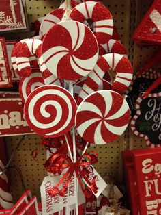 some lollipops are on display for sale in a store with red and white decorations