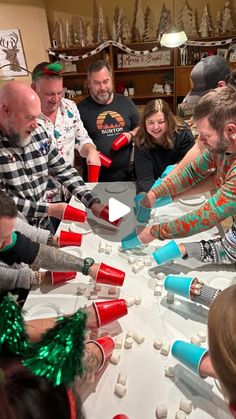 a group of people standing around a table