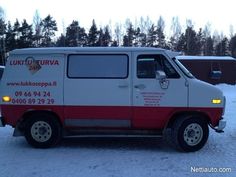 a white and red van parked in the snow