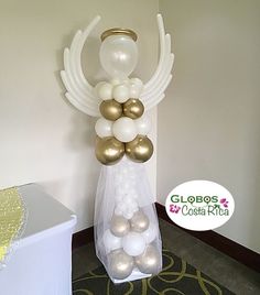 a balloon arch with white and gold balloons