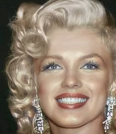 a close up of a woman with blonde hair and blue eyeshadow wearing earrings