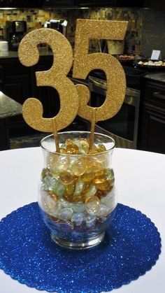 there is a small glass with some candy in it and the number 35 on top