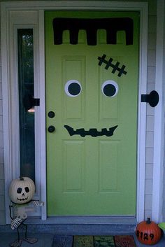 a green door decorated to look like a monster