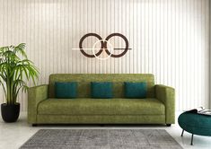 a living room with a green couch, chair and potted plant