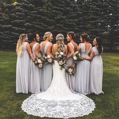 a group of women standing next to each other on top of a lush green field