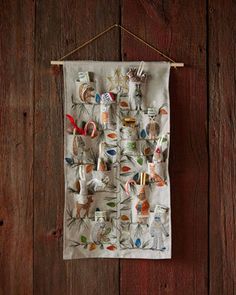 a tea towel hanging on a wooden wall with an animal print and other items attached to it