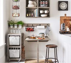 a small kitchen with white walls and wooden floors