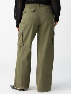 DETAILS Standard Rise Relaxed Fit Cargo Pant Micro-Sanded Super Soft Baby Twill Fabric Button/ Zipper Closure Fastener Detail at Hips Functional Cargo Pockets Also Available in XXS-XXL. SIZE + FIT Model is 5'10 wearing a size 1X. Waist: 39 1/2" Front Rise: 12 1/2" Inseam: 32 1/2" Leg Opening: 23" FABRIC + CARE 97% Cotton 3% Spandex Twill Style is Pre-Washed and Garment-Dyed. Machine Wash Cold, Tumble Dry Low. Imported BETTER COTTON'S MISSION By choosing our cotton products, you're supporting our Wide Leg Cargo Pants, Cotton Cargo Pants, Mossy Green, Baskets Adidas, Karl Kani, Baggy Pant, Military Inspired, Cargo Pant, Twill Fabric