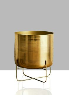 a large brass pot on a metal stand