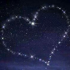 a heart shaped object with stars in the background