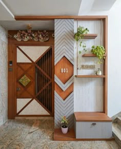 an entry way with wooden shelves and plants on the top shelf, next to a set of stairs