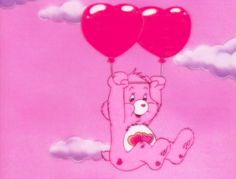 a pink bear holding two red balloons in the air