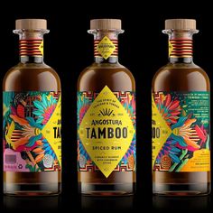 three bottles of tambo spice rum on a black background, with the label printed in bright colors