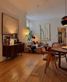 a living room filled with furniture and wooden floors