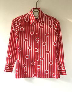 "True vintage top, featuring all over bold red and white geometric pattern, topped with a stately winged collar and classic button up placket. Designer label removed. Approximate Measurements: Shoulder: 14\"; Chest: 35\"; Length: 24.5\"; Labeled a Size 8 Fabric: 100% polyester Eye catching retro blouse, circa 1960s, is in excellent vintage condition. Enjoy! *(International Buyers are welcome - however, please email me so I can check the shipping rate for you before committing to buy.) bt" Red Graphic Print Button-up Top, Formal Spread Collar Printed Top, Formal Printed Tops With Spread Collar, Formal Printed Top With Spread Collar, Red Printed Button-up Top, Classic Fitted Patterned Tops, Classic Printed Tops For Formal Occasions, Classic Patterned Top For Formal Occasions, Patterned Fitted Top For Formal Occasions