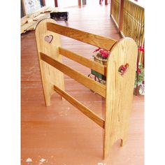 a wooden bench sitting on top of a hard wood floor next to a planter