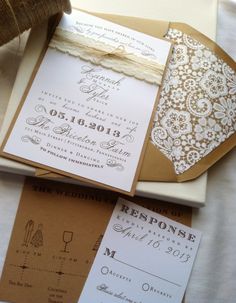 the wedding stationery is laid out on top of each other