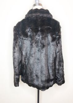 This is a faux fur, reversible jacket by Mackintosh, New England. The fur is soft and cozy and has the look of mink. The buttons look like horn and add a fun vintage flair. The reverse side is brown water resistant fabric, with fur trim. There is some creasing in the reverse fabric (see picture 7) which does not effect wearability. This is a stylish and very practical jacket, ready for whatever Mother Nature has in store. Size tag L. Check measurements carefully. Measurements taken with jacket l Long Sleeve Faux Fur Mink Coat, Mink-colored Faux Fur Coat, Faux Fur Lined Mink Coat, Mink Faux Fur Coat With Faux Fur Lining, Mink Colored Faux Fur Coat, Mink Outerwear With Faux Fur Trim For Cold Weather, Fall Mink Color Fur Coat With Faux Fur Trim, Mink Faux Fur Coat, Brown Water