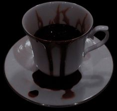 a white and black coffee cup with saucer