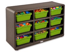 a toy storage unit with green bins filled with toys