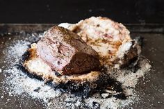 a piece of meat sitting on top of some flour