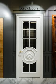 the front door to astro doors is white and has a circular glass panel on it