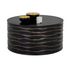 a black and gold coffee table with two cups on it's top, sitting in front of a white background