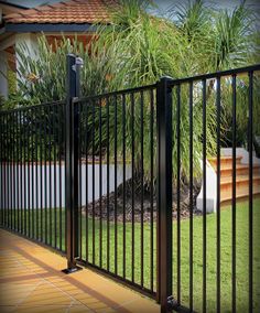 an iron fence in front of a house