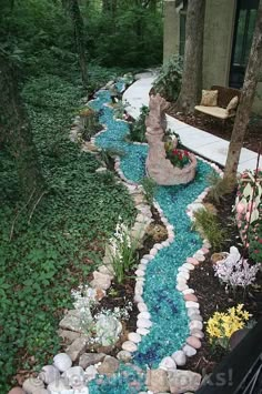 a garden with rocks and water running through it