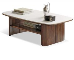 a coffee table with books and an alarm clock on it's side, in front of a white background